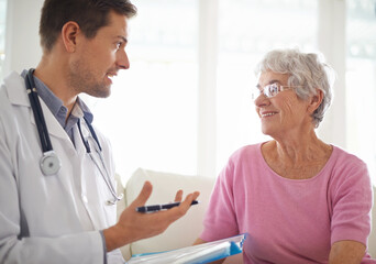 Canvas Print - Youre in good health. Shot of a male doctor explaining something to his senior patient.