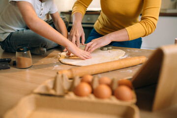 Wall Mural - mother and her child preparing food in kitchen