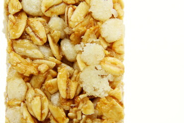 Wall Mural - tasty granola oats bar closeup on white background with copy space