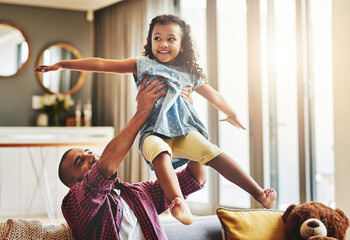 Aufkleber - Next destination, fun. Shot of an adorable little girl and her father playing together on the sofa at home.