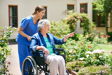 Id Like To Go That Way. Shot Of A Resident And A Nurse Outside In The Retirement Home Garden.