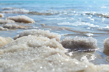 Wall Mural - Close up of salt background. Natural salt. Dead Sea salt mineral natural formations. Salt crystals from Dead sea. View of Dead Sea coastline. Texture of Dead sea. Salty seashore rocks