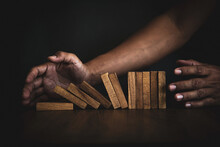 Close-up Hands Prevent Wooden Block Falling Domino Concepts Of Financial Risk Management And Strategic Planning