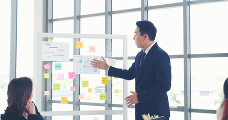 Poster - Happy business people meeting present graph chart investment, business data in meeting room. Group of business people meeting in conference room. Asian businessman speech, present teamwork partnership