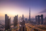Fototapeta  - Modern city skyline and cityscape at sunrise in Dubai UAE