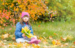 © Ermolaev Alexandr - Happy young girl with down syndrome sitting on autumn leaves. Empty space for text