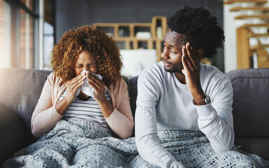 Wall Mural - flu season has arrived. shot of a young man getting irritated by his girlfriend suffering with aller