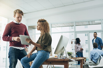 Aufkleber - Producing results with just a few taps. Shot of two young colleagues using a digital tablet together in a modern office.