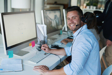 Aufkleber - Putting a positive spin on his calls. Portrait of a happy and confident young man working in a call center.