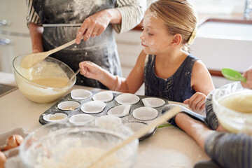 Poster - Almost ready for the over. Shot of two little girls baking with their mother in the kitchen.