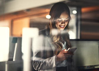 Aufkleber - You got to work for what you want. Cropped shot of a young attractive businesswoman using a tablet while working late at night in the office.