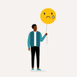 Young Black Man Holding And Looking At His Yellow Balloon With Sad Face. Negative Emotion.