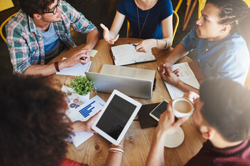 Poster - Its all about getting the best grade. High angle shot of a group of students studying in a coffee shop.