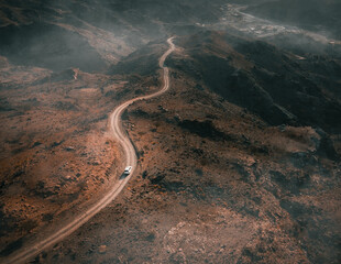 Wall Mural - Drone shot over the paved road in the mountains