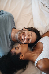 Youre the reason for my happiness. Cropped shot of a happy young couple lying in bed together.