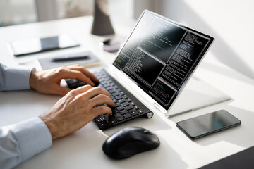 Computer Programmer Writing Program Code On Computer