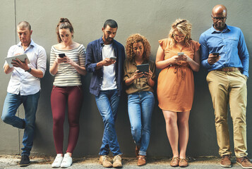 Aufkleber - Social networking helps reach people easier and quicker. Shot of a diverse group of people social networking outside.