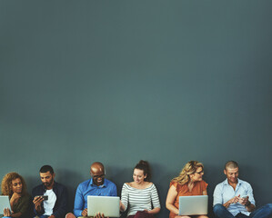 Aufkleber - Connecting while we are connected. Studio shot of a diverse group of people social networking against a gray background.