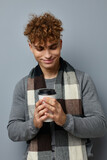 Fototapeta  - stylish guy checkered scarf posing drink mug isolated background