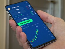 Stock world exchange FAANG etf market chart, stock market data on smartphone. Business analysis of a trend exchange-traded fund. Invest in international faang ETF