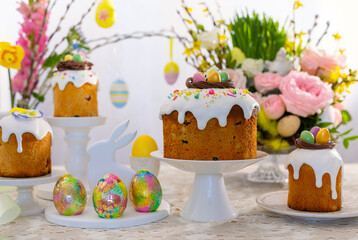 Wall Mural - Festive Easter table setting. Easter cake, Easter Eggs, Flower arrangements and home decorations for holiday.