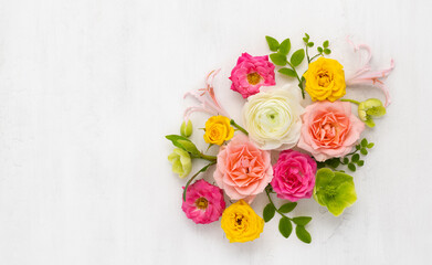 Wall Mural - Roses Arrangement. Composition of colorful Roses Flowers and green leaves on light background. Top view