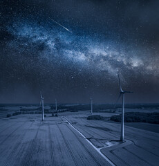 Wall Mural - milky way and wind turbines on field. alternative energy, poland.