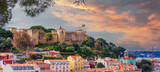 Fototapeta Desenie - Panorama of the Lisbon city and Castelo de Sao Jorge, known as the Saint George historical castle, at sunset