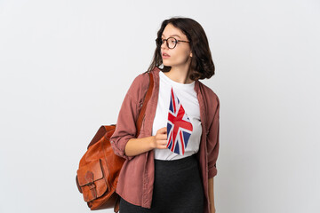 Wall Mural - Teenager Ukrainian girl holding an United Kingdom flag looking to the side