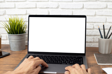 Wall Mural - mock up empty screen notebook, businessman working on his laptop computer with blank space screen for advertising text on wood desk in office