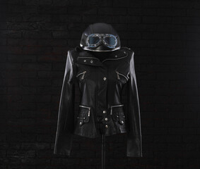 Wall Mural - black leather jacket with studs on a black background