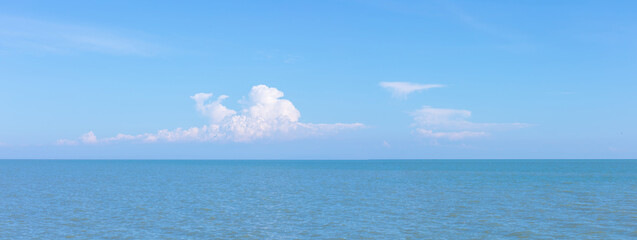 Wall Mural - landscape photo of sea or ocean with blue sky and white clouds.