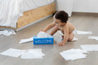 © Lisa Tichané - Baby playing with tissue paper box