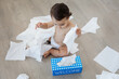 © Lisa Tichané - Baby emptying a box of tissue paper