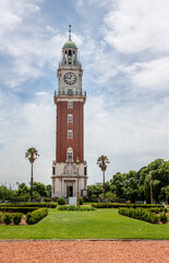 Poster - A high red and white tower with a large clock with a green dome