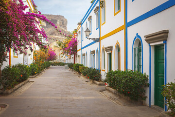 Street with bougainvillea flowers in Puerto Mogan, Gran Canaria island, Spain