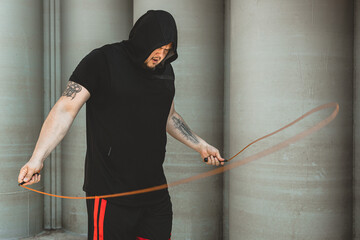 Poster - Caucasian man fighter training hard in the outdoors.. Man using rope, making warm up. concept about sport and boxing