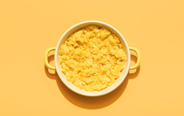 Scrambled eggs above view minimalist on an orange background