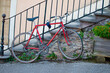 French retro old race bicycle locked to the fence - Cremieu city