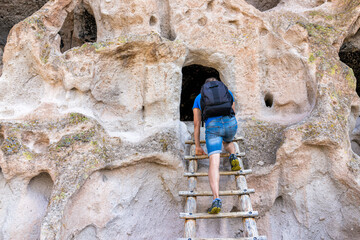 Wall Mural - man climbing up ladder on main loop trail in bandelier national monument in new mexico during summer
