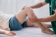 © OMEGA - Treating thigh pain due to sitting for long periods of time Concept of physical rehabilitation. Consultation therapist with the treatment of treating injured thigh pain in modern clinics.