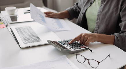 Wall Mural - Woman accountant using calculator and computer in office panoramic banner, finance and accounting concept