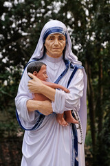 Wall Mural - Mother Teresa statue infront of the Catholic Church in Kumrokhali, West Bengal, India