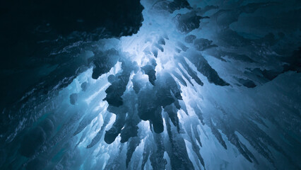 Beautiful shot underwater of ice pieces on blue water with white light