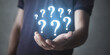 © andranik123 - Male hand holding question marks.