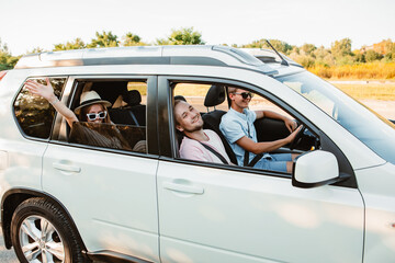 Wall Mural - friends in car looking from the window