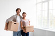 © Prostock-studio - Glad millennial caucasian man and woman in casual carry boxes, hugs and enjoy renting new flat in empty room