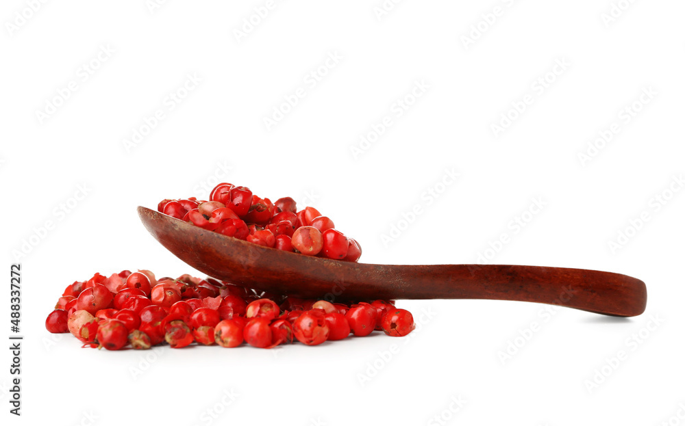 Spoon with red peppercorns isolated on white background