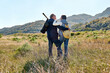 © Caterina Trimarchi - Rear view of a couple hugging while walking through a rural mead