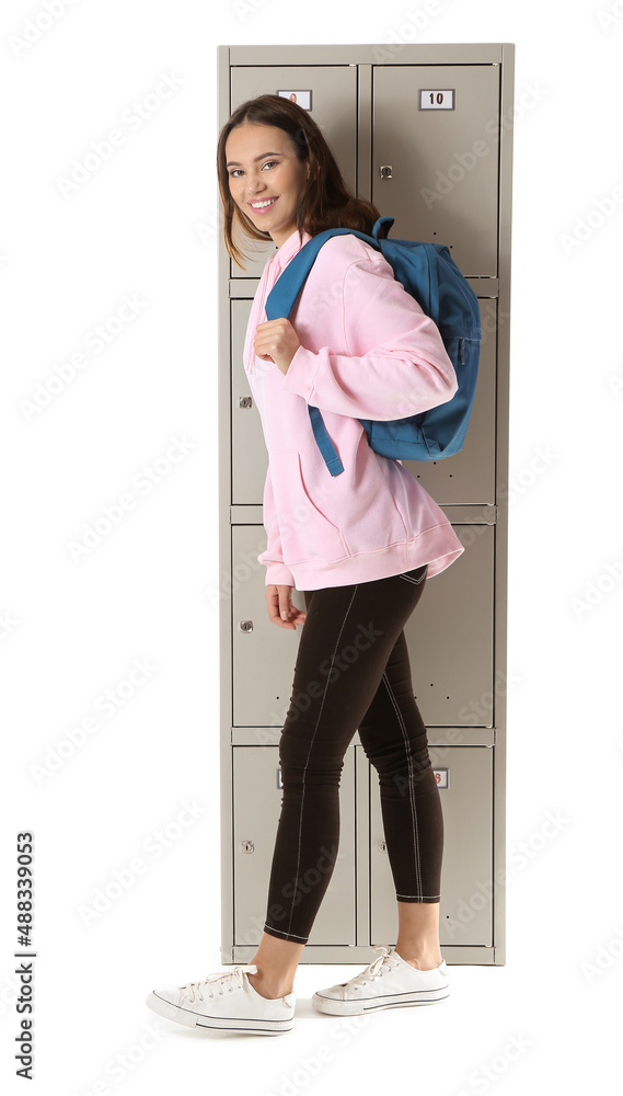Beautiful female student near locker on white background